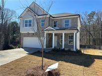 Two-story brick home with a white front door and attached garage at 566 Abbott Se Ct, Atlanta, GA 30354