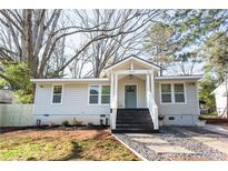 Charming craftsman style home with gray siding, modern front door, and landscaped yard at 3377 Phillip Cir, Decatur, GA 30032