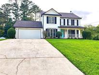 Two-story house with white siding, black shutters, and a grassy yard at 125 Cinnamon Fern Cir, Covington, GA 30016