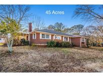 Brick ranch house on 45 acres with a screened porch at 1921 W Hightower W Trl, Conyers, GA 30012