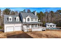 Two-story house with attached garage and inground pool at 3246 E 5 E Hwy, Carrollton, GA 30116