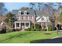 Two-story brick home with a large front yard and driveway at 4675 Allistair Dr, Cumming, GA 30040