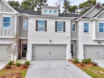 Modern two-story townhome with gray siding and attached garage at 5435 Rock Place Ct # 38, Norcross, GA 30093