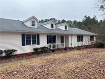 Charming home featuring a white exterior, dormer windows, a covered porch, and a well-maintained front yard at 850 Thurman Rd, Stockbridge, GA 30281