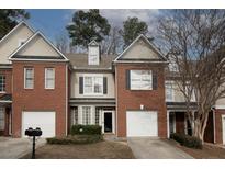 Brick townhouse with attached garage and landscaping at 2353 Maplewood Se Ct # 25, Atlanta, GA 30339