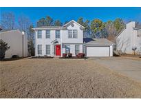 Two-story house with white siding, red door, and attached garage at 3945 Brushy Creek Way, Suwanee, GA 30024