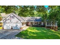 Ranch style home with attached two-car garage and landscaped lawn at 4692 Yeager Rd, Douglasville, GA 30135