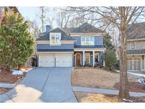 Stunning two-story home with a gray exterior, double garage, and manicured lawn at 1103 Ridenour Ct, Kennesaw, GA 30152