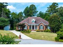 Charming brick home with a meticulously landscaped yard, inviting curb appeal and classic architectural details at 1440 Eugenia Ter, Lawrenceville, GA 30046