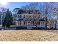 Two-story house with a wraparound porch and large yard at 1494 Willow Bnd, Woodstock, GA 30188