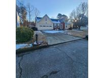 Ranch style home with attached garage and landscaped yard at 2210 Burdett Ridge, Atlanta, GA 30349