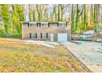 Brick ranch home with attached garage and driveway at 2836 Crescendo Dr, Atlanta, GA 30318