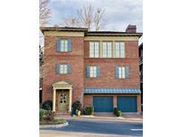 Attractive brick exterior with blue accents, a portico over the front door, and a two-car garage at 5890 Bond St, Cumming, GA 30040