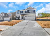 Two-story home with gray siding, attached garage, and a landscaped yard at , Stone Mountain, GA 30087