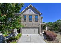 Brick front exterior of charming townhome with two-car garage at 2396 Whiteoak Se Bnd # 16, Smyrna, GA 30080