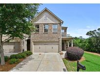 Charming two-story home featuring a brick facade, two-car garage, and a well-maintained landscaped front yard at 2396 Whiteoak Se Bnd # 16, Smyrna, GA 30080