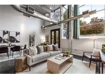 Open living area with high ceilings, exposed ductwork, and large windows at 400 Village Ne Pkwy # 120, Atlanta, GA 30306