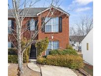 Brick townhouse with black shutters and a landscaped front yard at 5547 Strathmoor Manor Cir, Lithonia, GA 30058