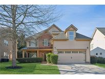 Two story house with a large front yard and attached two-car garage at 2175 Creole Cir, Cumming, GA 30040