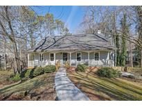 Gray house with wrap around porch and landscaped yard at 3796 Hickory Ridge Ct, Marietta, GA 30066