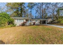 Ranch style home with carport and landscaped yard at 3110 Mcafee Rd, Decatur, GA 30032