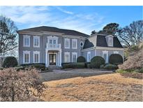 Stunning two-story home with a classic facade and manicured lawn at 4720 Cliffside Ct, Marietta, GA 30067