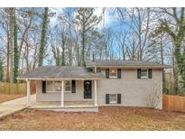 Charming, single-story house with a covered front porch, offering a welcoming entrance and great curb appeal at 1963 Shannon Ridge Ct, Decatur, GA 30032