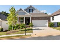 Brick and shingle ranch home with two-car garage and landscaped yard at 113 Overlook Ridge Way, Canton, GA 30114