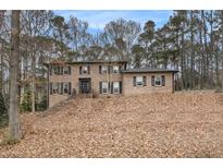 Charming two-story brick home with black shutters and a well-manicured lawn at 1514 Howell Highlands Dr, Stone Mountain, GA 30087