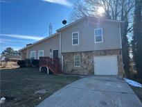 Two-story house with attached garage and wooden deck at 3690 Darrah Sw Way, Atlanta, GA 30331