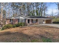 Brick ranch house with covered carport and landscaped yard at 3251 Wanda Woods Dr, Atlanta, GA 30340