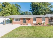 Brick Ranch home with carport, mature trees, and well-manicured lawn at 2649 Santa Barbara Nw Dr, Atlanta, GA 30318