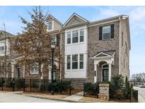 Charming brick townhome with black shutters, a fenced yard, and well-maintained landscaping at 3541 Koyla Lndg, Chamblee, GA 30341