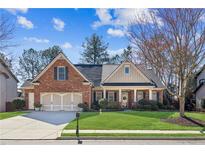 Charming brick home featuring a well-manicured lawn and a two-car garage, offering curb appeal and convenience at 535 Cape Ivey Dr, Dacula, GA 30019