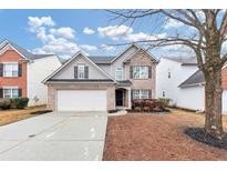 Two-story house with gray siding, brick accents, and a two-car garage at 2114 Black Oak Ln, Ellenwood, GA 30294