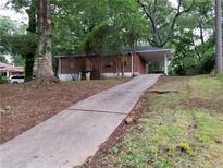 Brick ranch house with a long driveway, needing landscaping at 2484 Brentwood Rd, Decatur, GA 30032