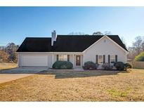 Ranch style home with gray siding, dark roof, and attached garage at 362 Mcgiboney Rd, Covington, GA 30016
