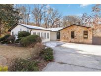 Updated house exterior boasts a modern white facade and stone accents at 1825 Niskey Lake Rd, Atlanta, GA 30331