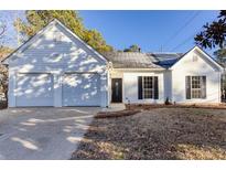 White house with two-car garage and landscaped yard at 4100 Chanticleer Nw Dr, Kennesaw, GA 30152