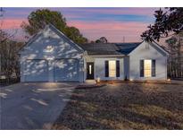 Charming single-story home with white siding, attached garage, and well-manicured lawn at 4100 Chanticleer Nw Dr, Kennesaw, GA 30152