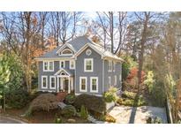 Charming two-story home with gray siding, white trim, mature trees, and well-maintained landscaping at 685 Greystone Ne Park, Atlanta, GA 30324