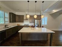 Spacious kitchen with island, stainless steel appliances, and dark wood cabinets at 5981 Brundage Ln, Norcross, GA 30071