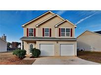 Two-story house with two-car garage and manicured landscaping at 4928 Bryant Dr, Snellville, GA 30039