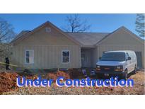 Newly constructed one-story home with light beige siding at 1810 Forkview Ct, Lawrenceville, GA 30044