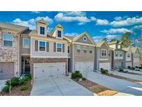 Modern townhouses with attached garages and landscaped yards at 2711 Kemp Ct, Conyers, GA 30094