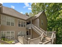 Exterior view of a condo building with stairs and wooden railings at 310 Mill Pond Se Ct, Smyrna, GA 30082