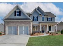 Two-story house with gray siding, brick accents, and a three-car garage at 441 Pine Way, Dallas, GA 30157