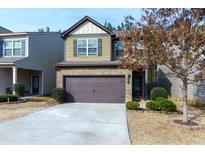 Two-story house with brown garage door and landscaped yard at 4505 Ravenwood Dr, Union City, GA 30291