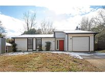 Ranch style home with red front door and attached garage at 406 River Chase Dr, Jonesboro, GA 30238