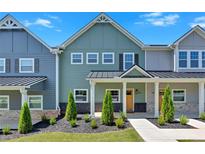Two-story townhome with inviting front porch and landscaping at 704 Fairgate Rd, Marietta, GA 30064